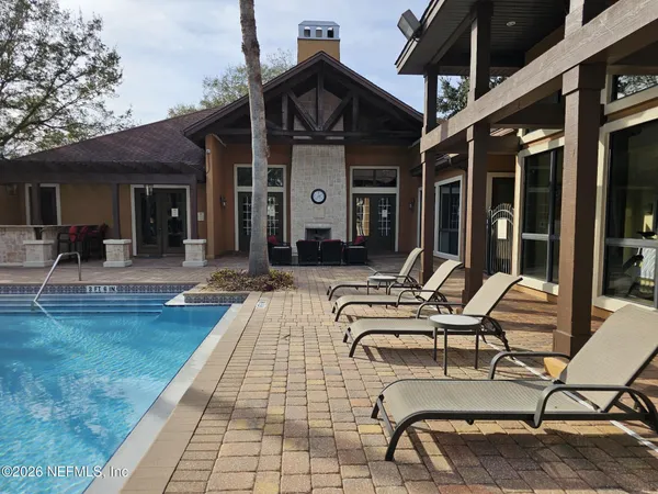 a view of a house with swimming pool and porch
