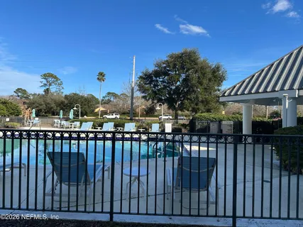 a view of a yard with wooden fence