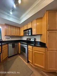 a view of a room with wooden floor and window
