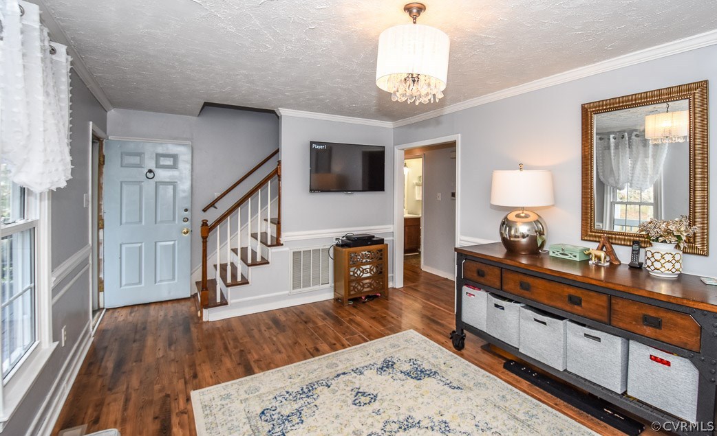2612 Colgrave Road Midlothian, VA 23112 - Photo 12 of 33 a large living room with wooden floors and a chandelier