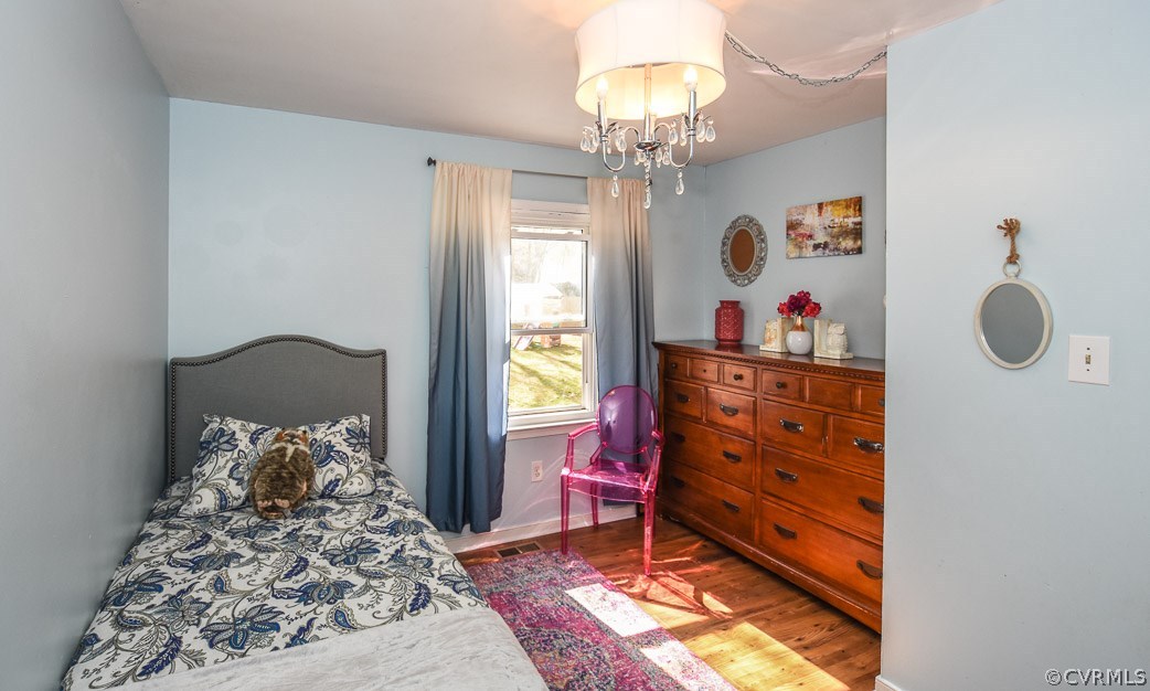 2612 Colgrave Road Midlothian, VA 23112 - Photo 29 of 33 a bedroom with a bed and a chandelier