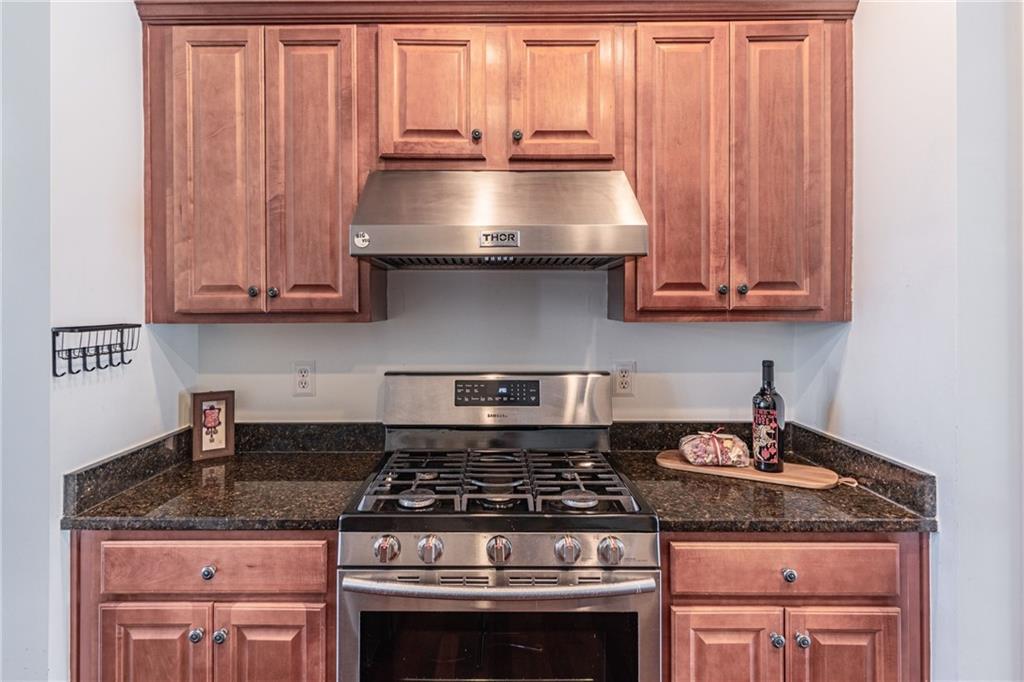 3487 Harvest Ridge Lane Northeast Buford, GA 30519 - Photo 14 of 34 a kitchen with granite countertop a stove and a sink