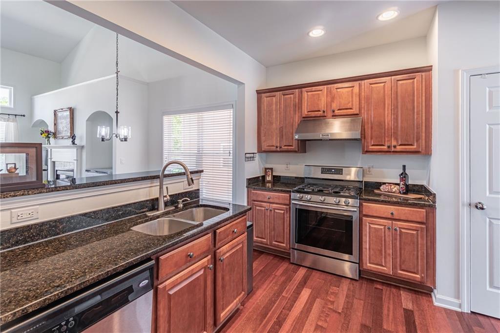 3487 Harvest Ridge Lane Northeast Buford, GA 30519 - Photo 15 of 34 a kitchen with stainless steel appliances granite countertop a sink stove and cabinets