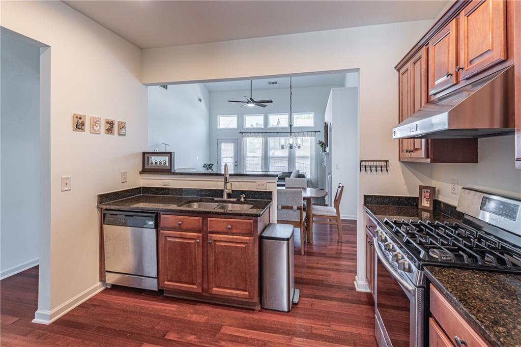 3487 Harvest Ridge Lane Northeast Buford, GA 30519 - Photo 16 of 34 a kitchen with granite countertop a stove and a sink