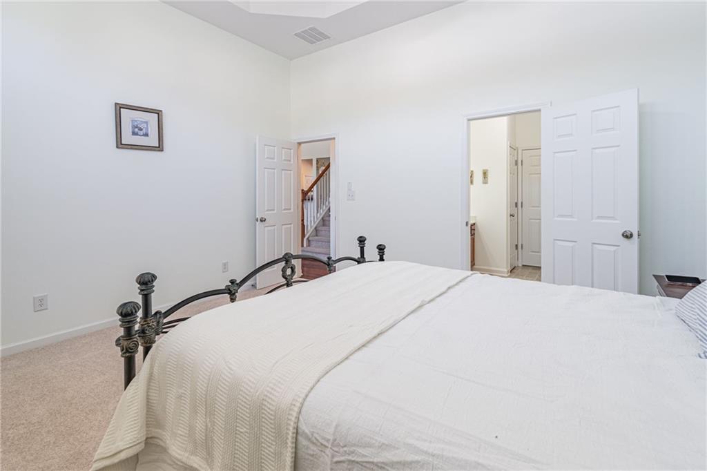 3487 Harvest Ridge Lane Northeast Buford, GA 30519 - Photo 19 of 34 a bedroom with a bed and a dresser