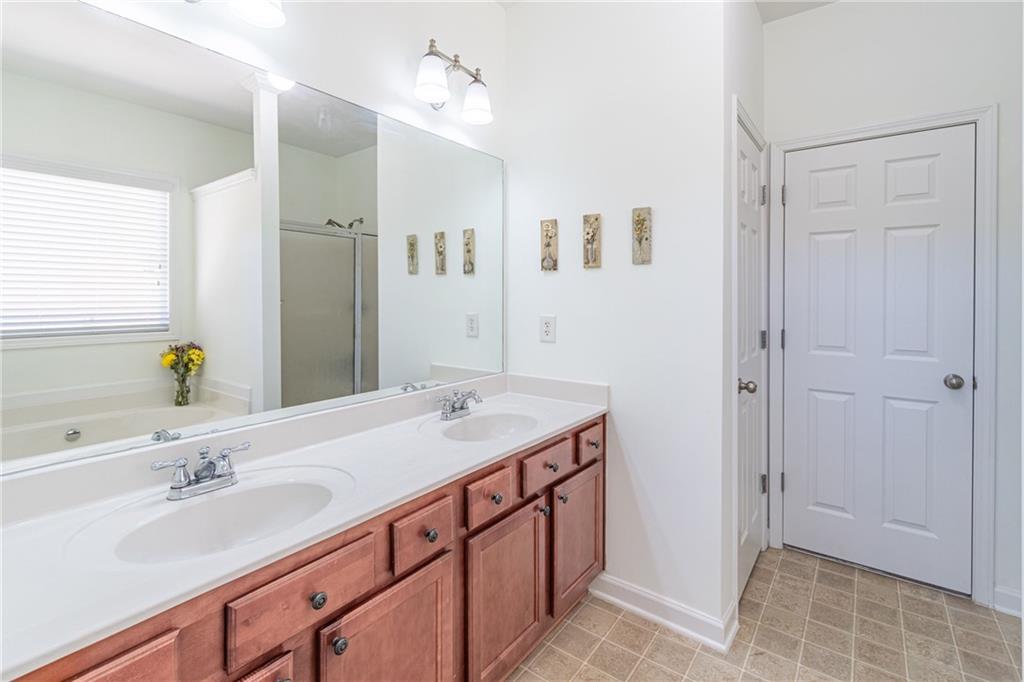 3487 Harvest Ridge Lane Northeast Buford, GA 30519 - Photo 20 of 34 a bathroom with a sink double vanity and a mirror