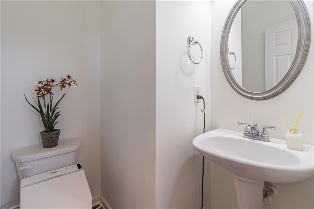 3487 Harvest Ridge Lane Northeast Buford, GA 30519 - Photo 22 of 34 a bathroom with a toilet a sink and a mirror