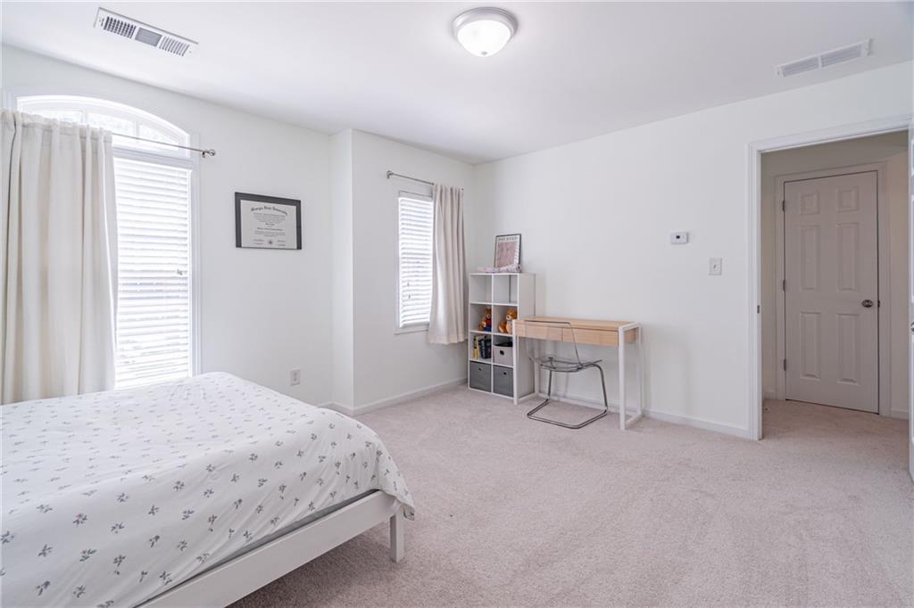 3487 Harvest Ridge Lane Northeast Buford, GA 30519 - Photo 23 of 34 a bedroom with a bed and a chair