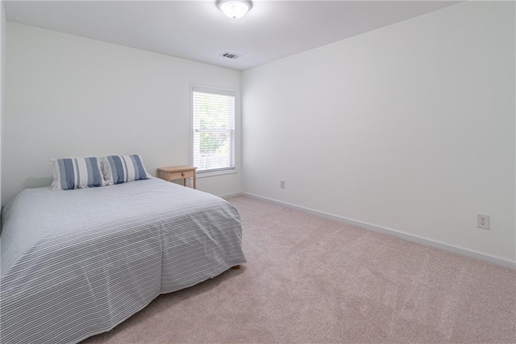 3487 Harvest Ridge Lane Northeast Buford, GA 30519 - Photo 30 of 34 a bedroom with a bed and a window