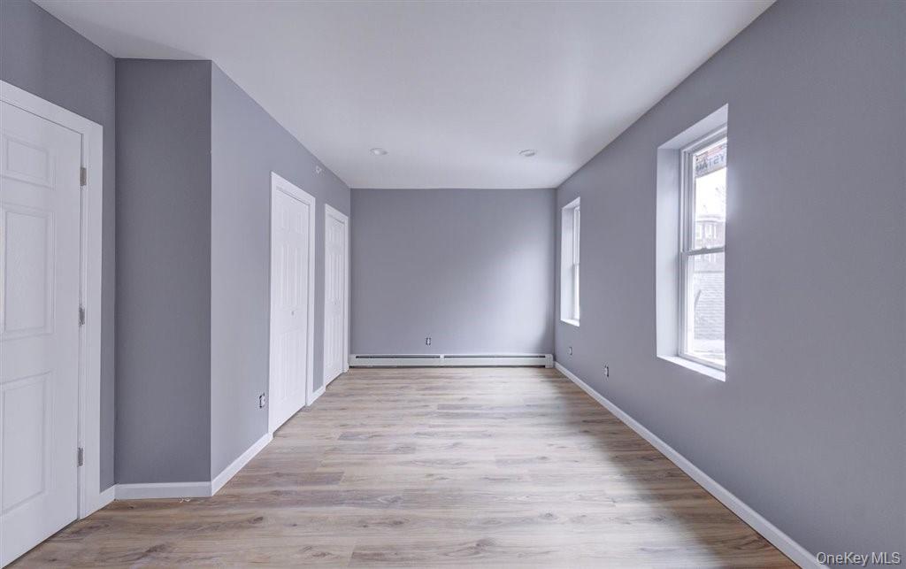 93 South Lander Street, Unit 2 Newburgh, NY 12550 - Photo 13 of 21 a view of an empty room with wooden floor and window