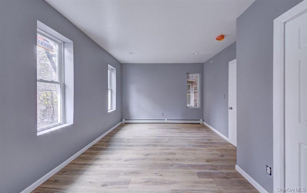 93 South Lander Street, Unit 2 Newburgh, NY 12550 - Photo 14 of 21 a view of an empty room with wooden floor and a window