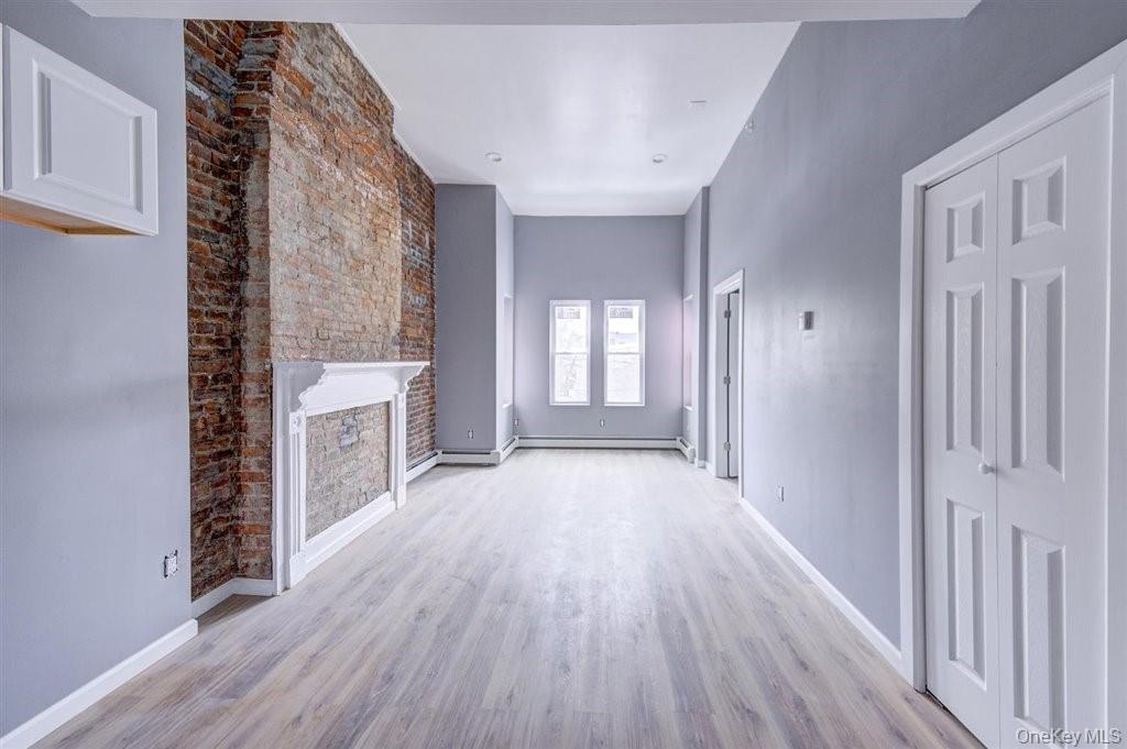 93 South Lander Street, Unit 2 Newburgh, NY 12550 - Photo 19 of 21 a view of a hallway with wooden floor and staircase