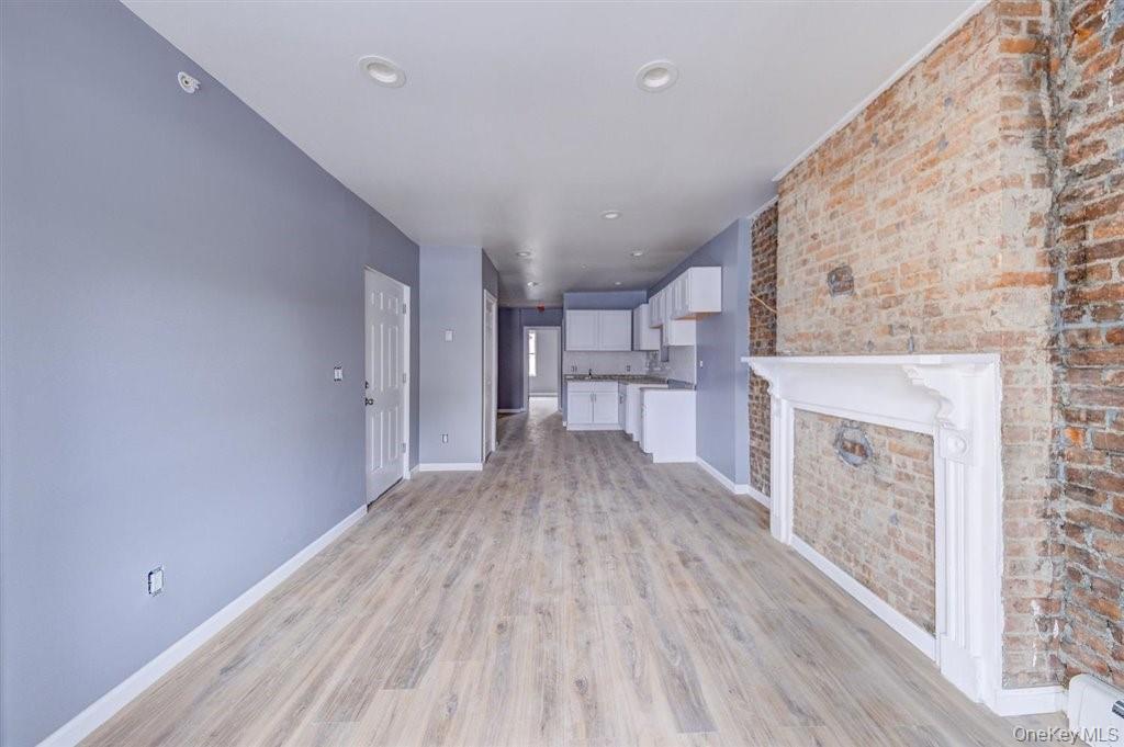 93 South Lander Street, Unit 2 Newburgh, NY 12550 - Photo 6 of 21 a view of a living room with a fireplace and wooden floor