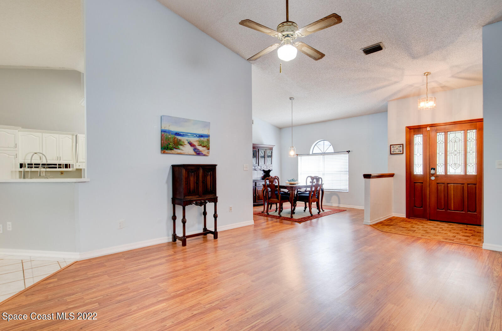 1250 North Carpenter Road Titusville, FL 32796 - Photo 11 of 52 a view of a livingroom with furniture wooden floor and a ceiling fan
