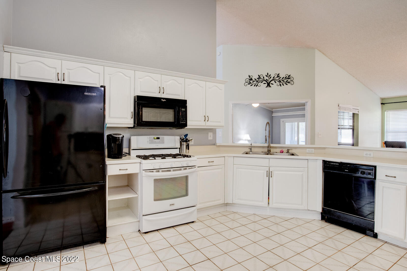 1250 North Carpenter Road Titusville, FL 32796 - Photo 16 of 52 a kitchen with a sink stainless steel appliances and cabinets