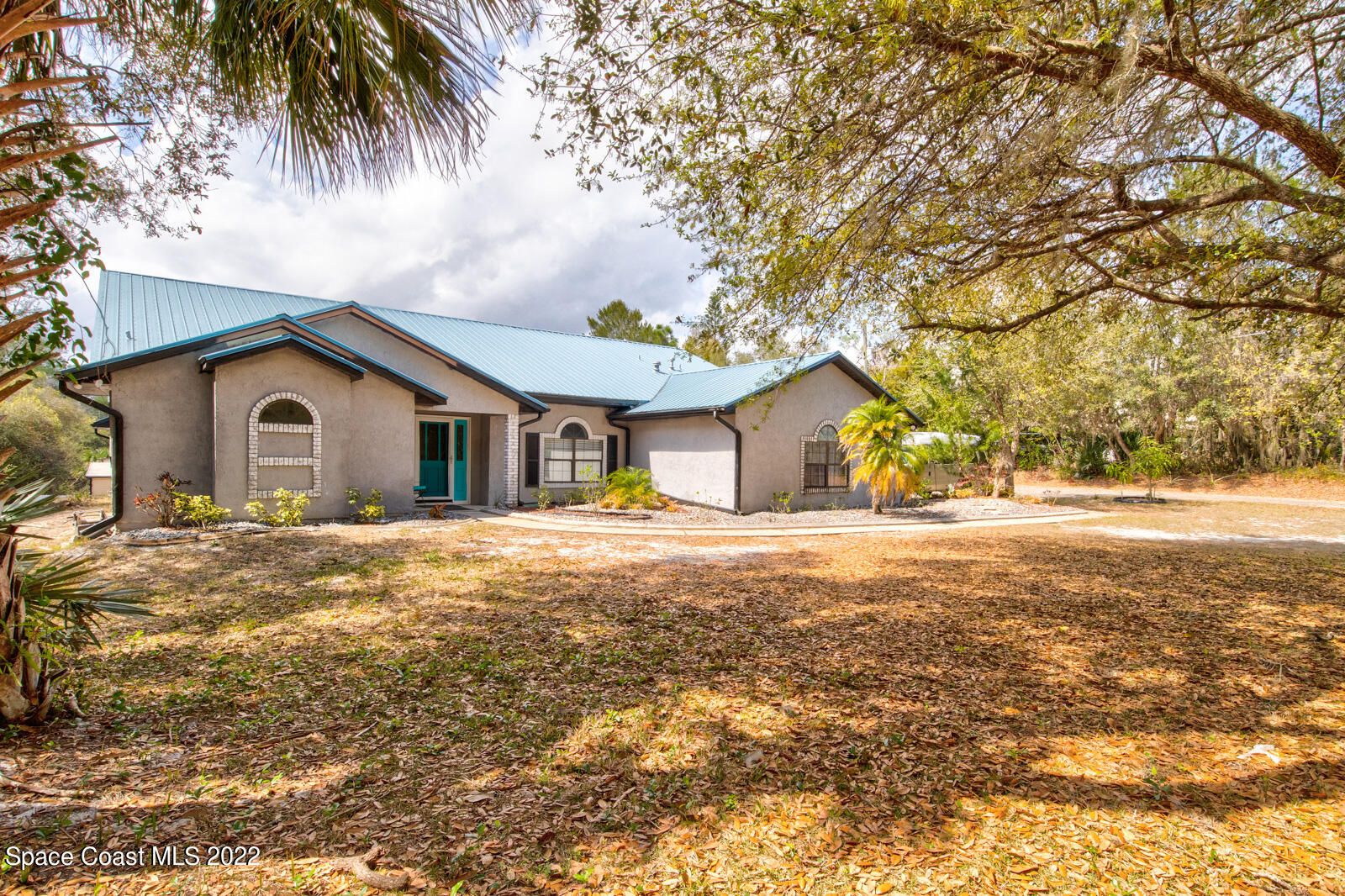 1250 North Carpenter Road Titusville, FL 32796 - Photo 2 of 52 a view of a house with a yard and tree