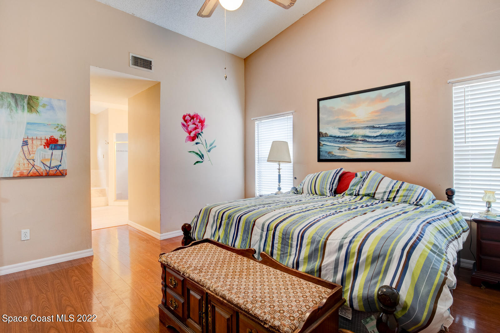 1250 North Carpenter Road Titusville, FL 32796 - Photo 21 of 52 a bedroom with a bed and a painting on the wall