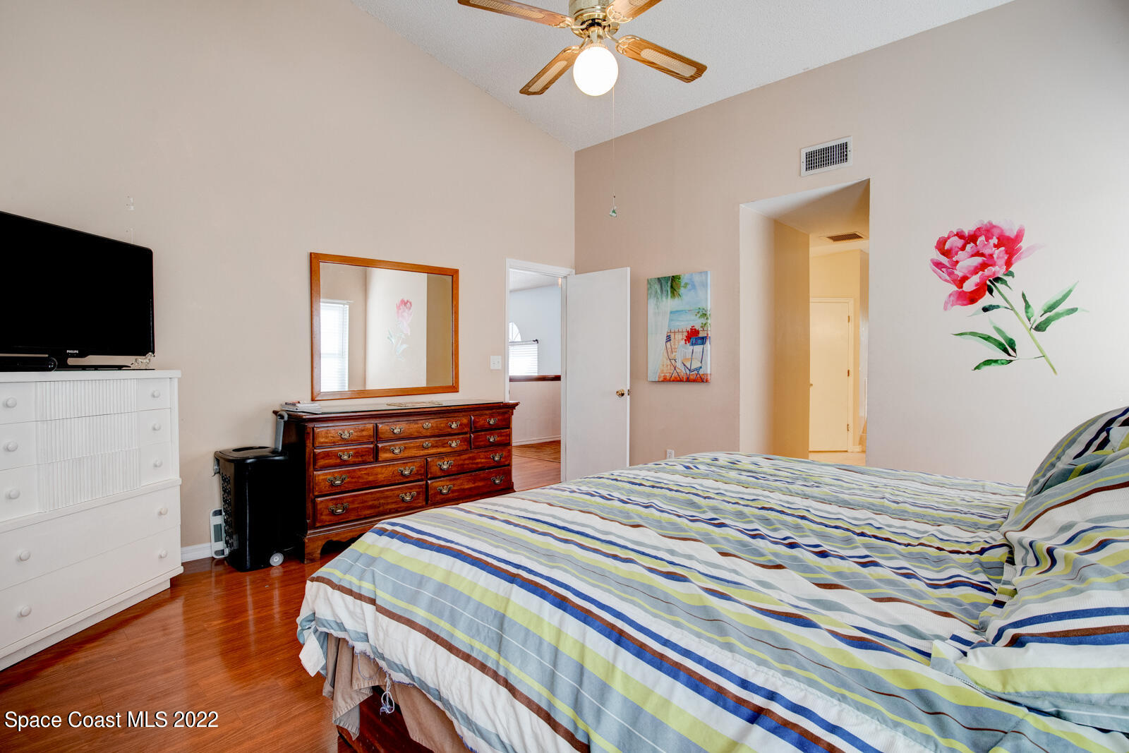 1250 North Carpenter Road Titusville, FL 32796 - Photo 22 of 52 a bedroom with a bed and a flat screen tv