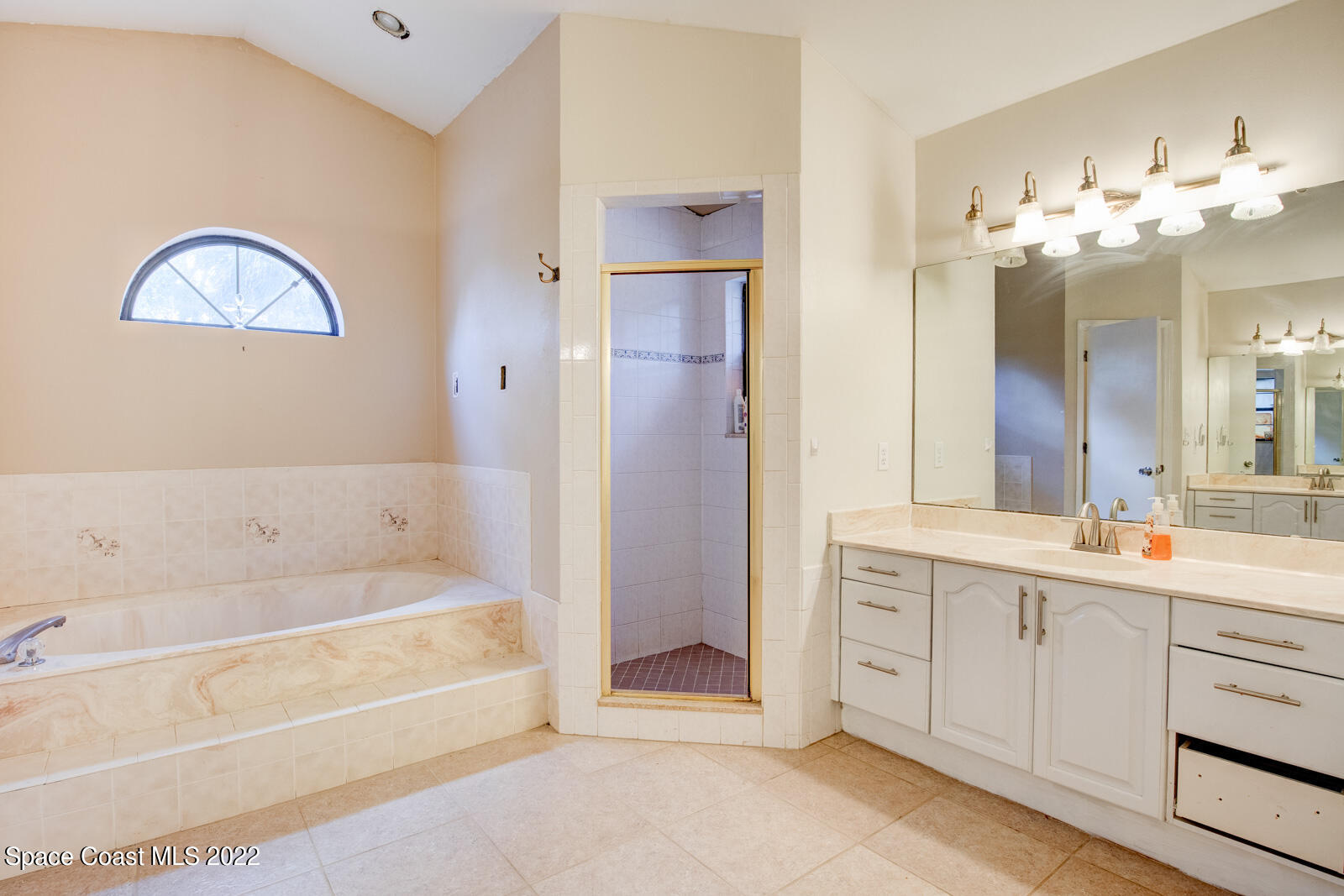 1250 North Carpenter Road Titusville, FL 32796 - Photo 24 of 52 a bathroom with a tub sink and mirror