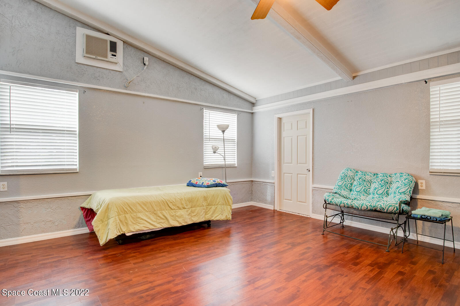 1250 North Carpenter Road Titusville, FL 32796 - Photo 27 of 52 a bedroom with a bed windows and wooden floor