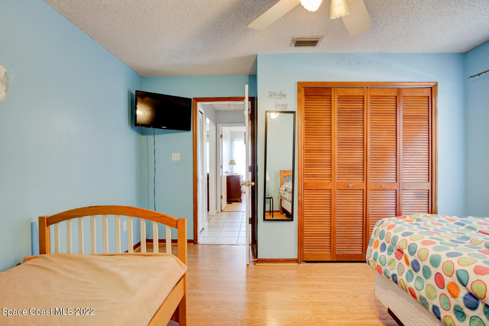 1250 North Carpenter Road Titusville, FL 32796 - Photo 31 of 52 a bedroom with a bed and a tv