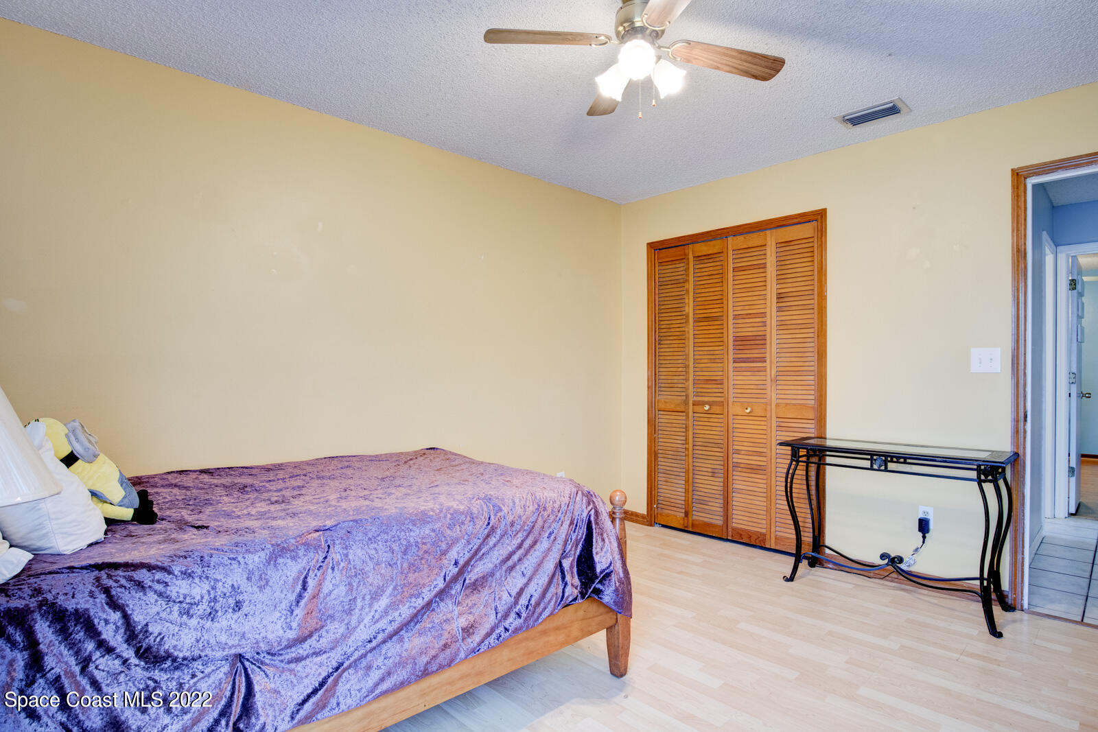 1250 North Carpenter Road Titusville, FL 32796 - Photo 33 of 52 a bedroom with a bed and cabinets