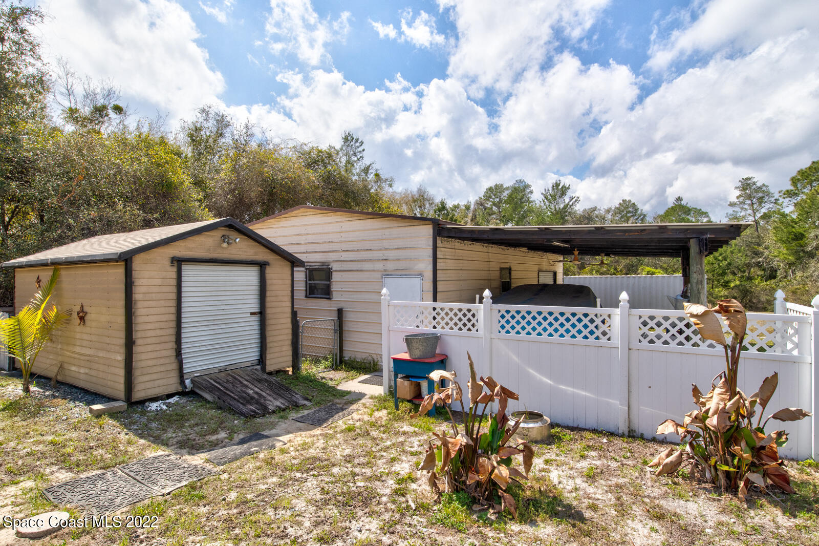 1250 North Carpenter Road Titusville, FL 32796 - Photo 40 of 52 a view of a house with a wooden fence