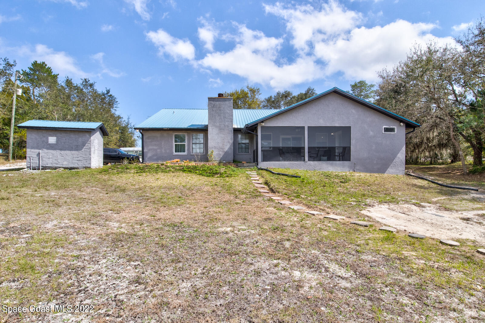 1250 North Carpenter Road Titusville, FL 32796 - Photo 43 of 52 a view of a house with a yard