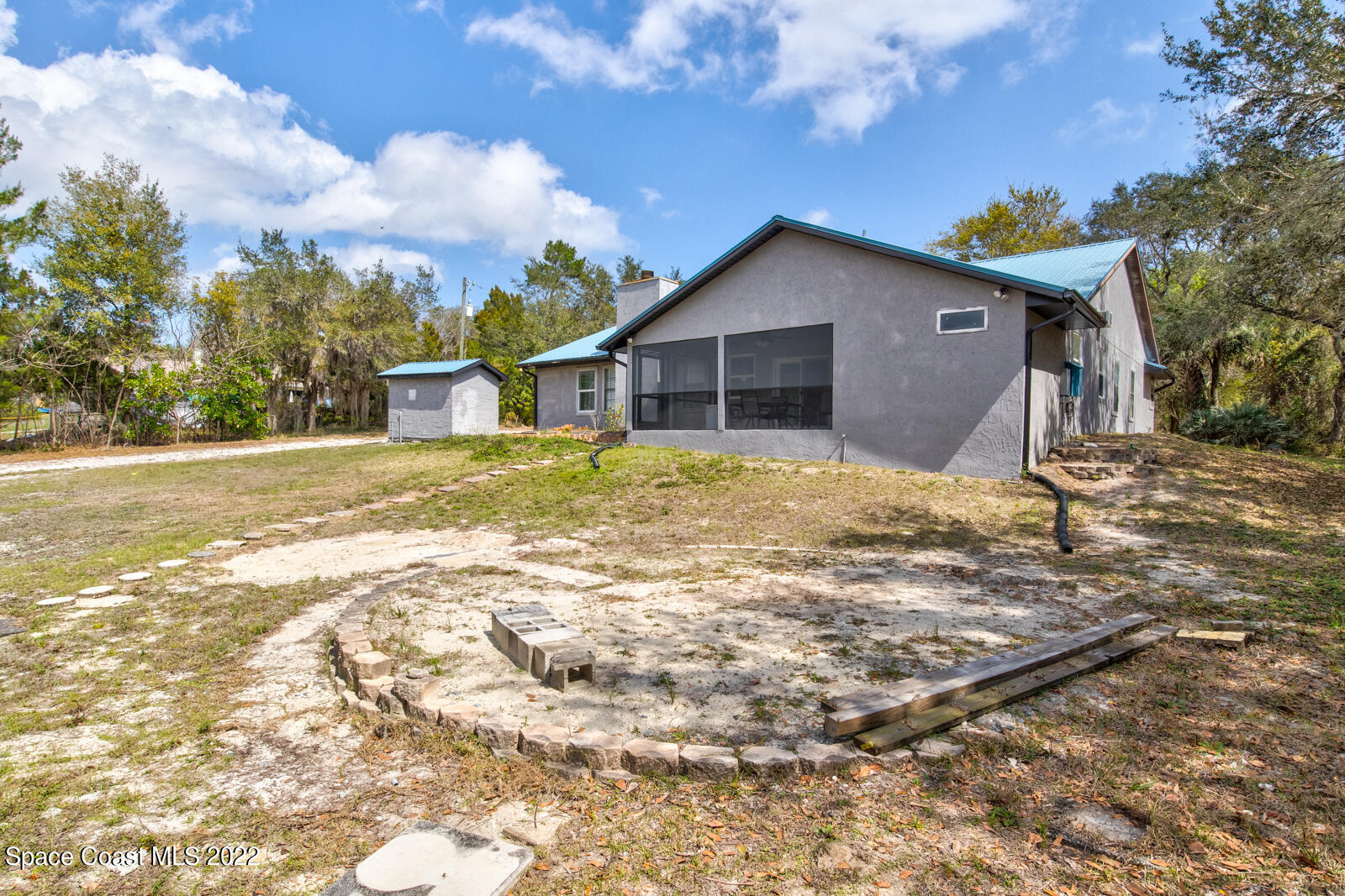 1250 North Carpenter Road Titusville, FL 32796 - Photo 44 of 52 a view of a house with a yard covered with snow in front of it
