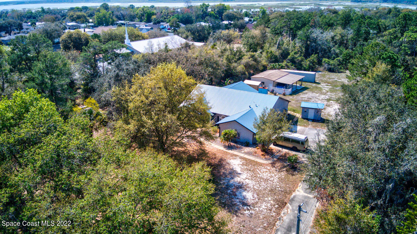 1250 North Carpenter Road Titusville, FL 32796 - Photo 46 of 52 an aerial view of a house with yard swimming pool and lake view