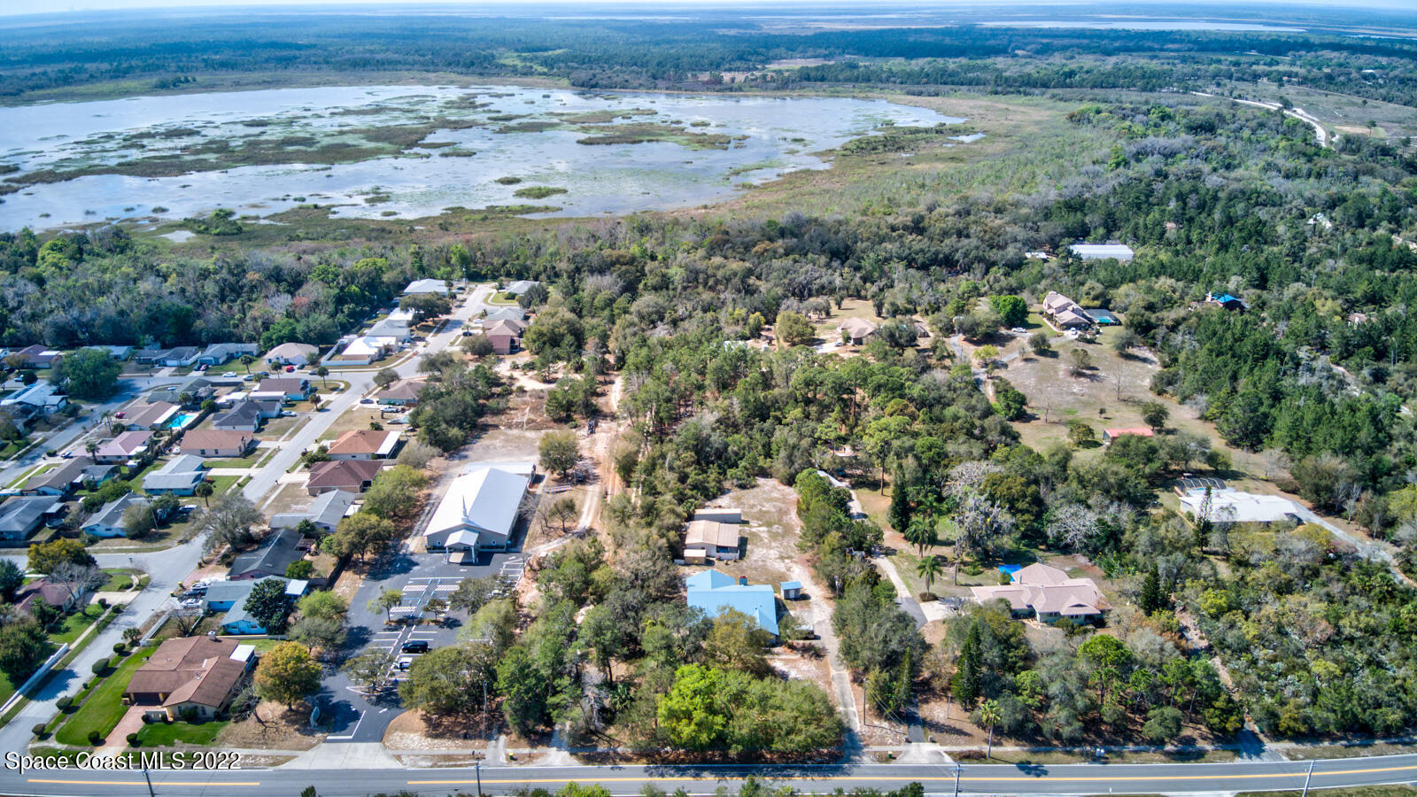 1250 North Carpenter Road Titusville, FL 32796 - Photo 49 of 52 an aerial view of residential houses with outdoor space and trees