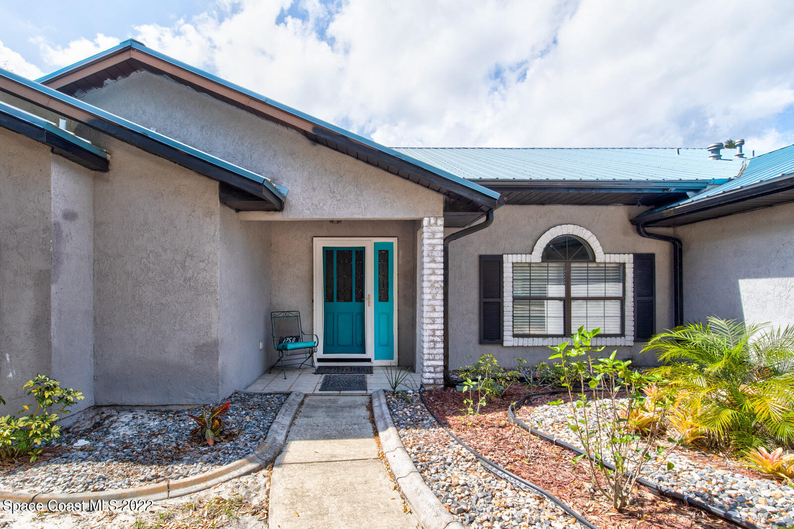 1250 North Carpenter Road Titusville, FL 32796 - Photo 5 of 52 a front view of a house with garden