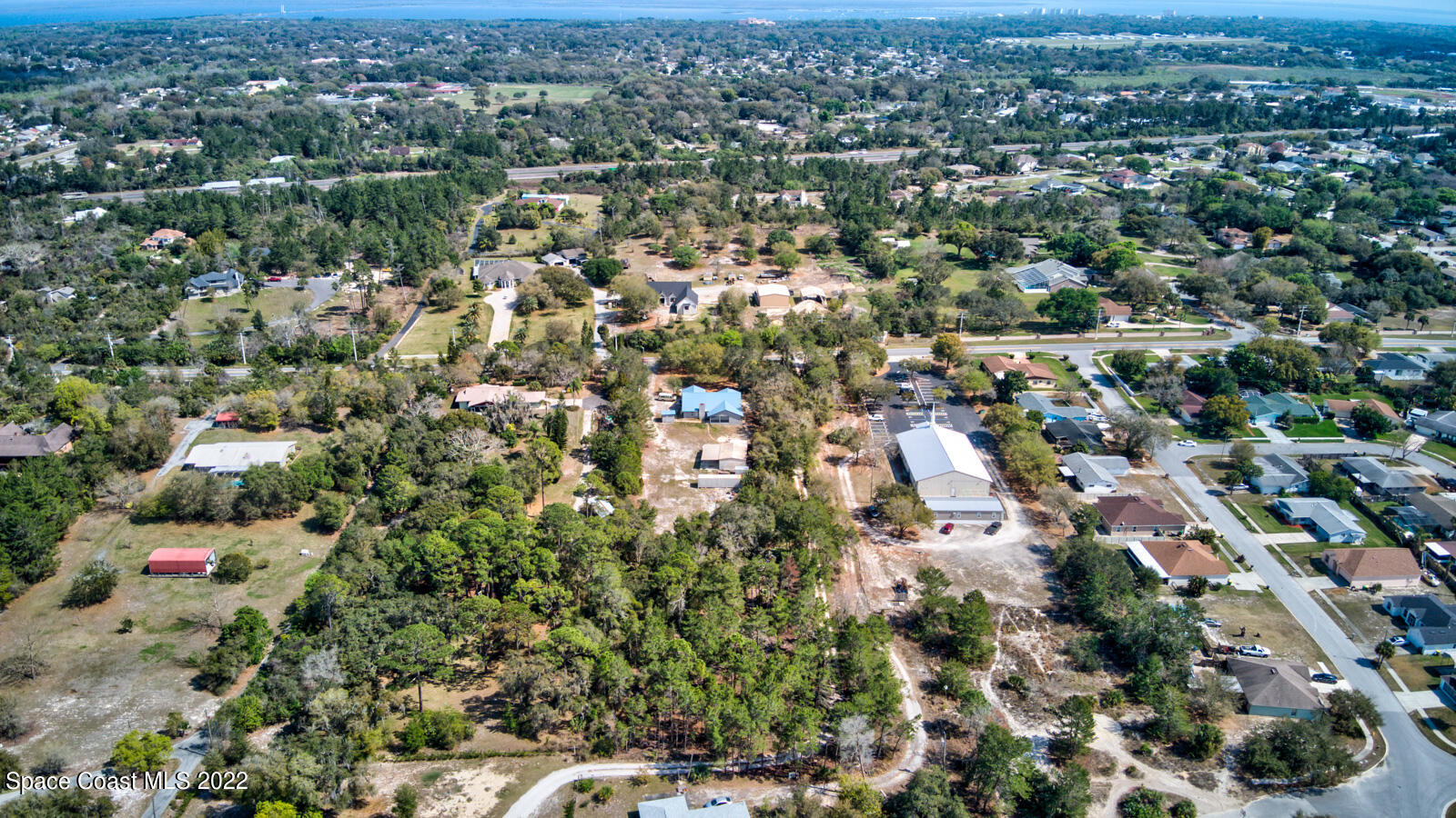 1250 North Carpenter Road Titusville, FL 32796 - Photo 51 of 52 an aerial view of residential houses with outdoor space and trees
