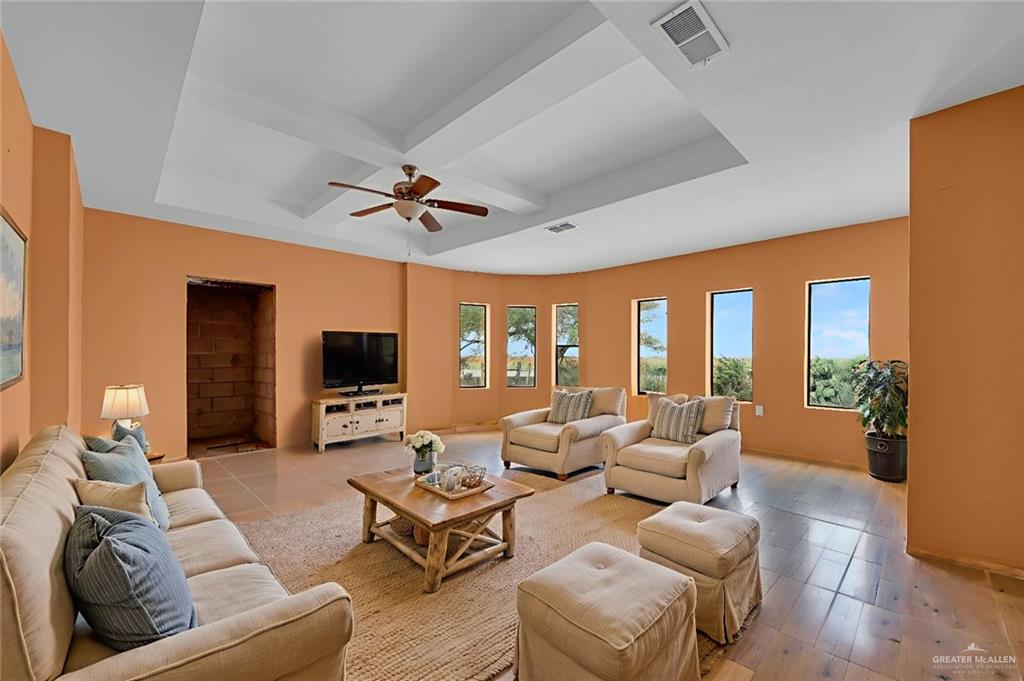 26821 Brushline Road Edinburg, TX 78542 - Photo 3 of 11 a living room with furniture ceiling fan and a flat screen tv