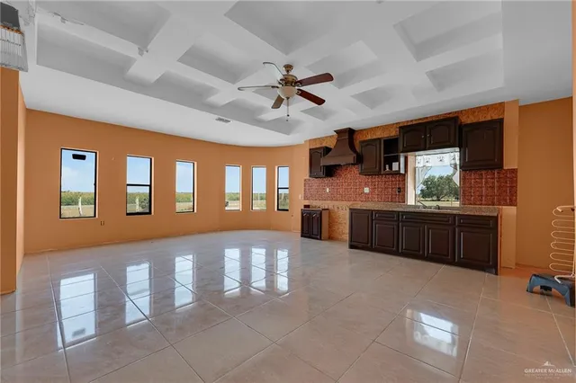 a view of a kitchen with a sink and a refrigerator