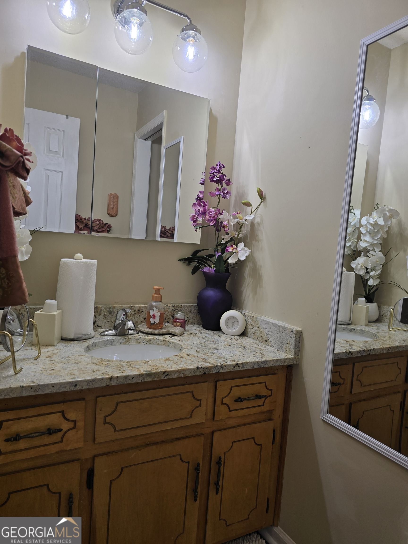 479 Mitchell Loop Bluffton, GA 39824 - Photo 31 of 51 a bathroom with a granite countertop sink and a mirror