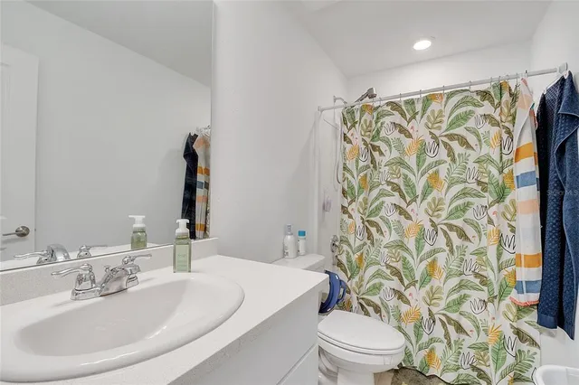 a room with a bed and a dresser