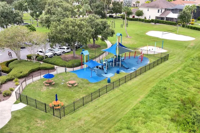 a swimming pool with a yard and outdoor seating