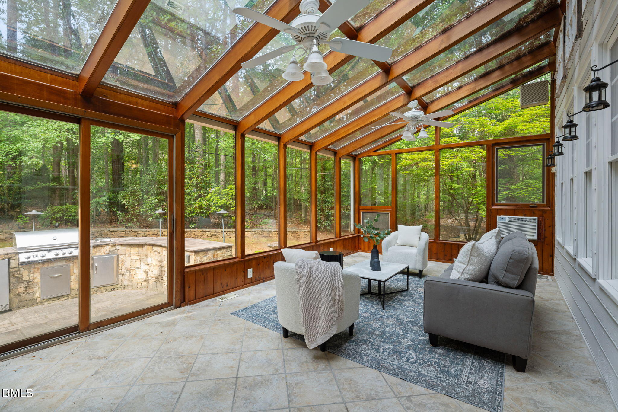 5809 Stone Spring Road Raleigh, NC 27613 - Photo 38 of 54 a living room with furniture and floor to ceiling windows