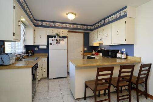 284 Paddock Circle Glendale Heights, IL 60139 - Photo 11 of 11 a kitchen with a refrigerator a stove a sink and cabinets