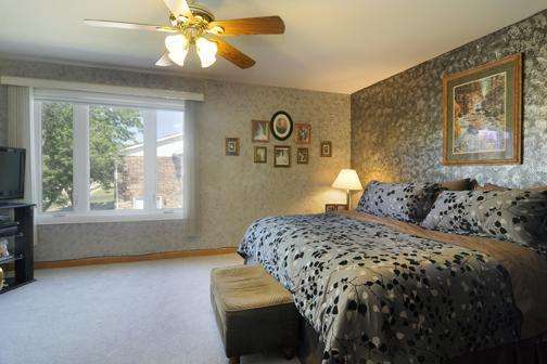 284 Paddock Circle Glendale Heights, IL 60139 - Photo 5 of 11 a bedroom with a bed and a window