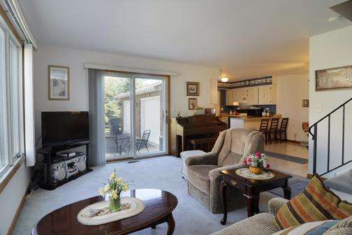 284 Paddock Circle Glendale Heights, IL 60139 - Photo 7 of 11 a living room with furniture kitchen view and a large window