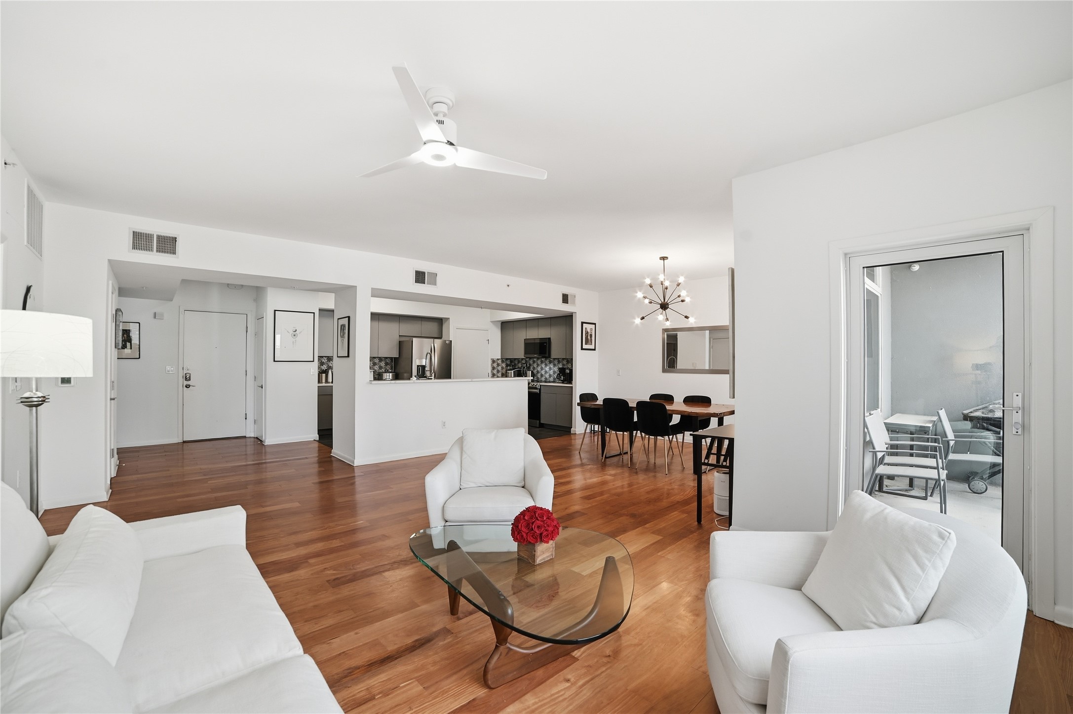 54 Rainey Street, Unit 1018 Austin, TX 78701 - Photo 3 of 32 a living room with furniture and a wooden floor