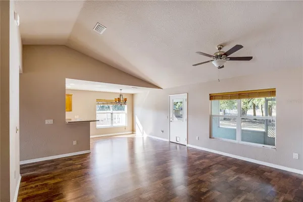 a kitchen with granite countertop a refrigerator a stove and a sink