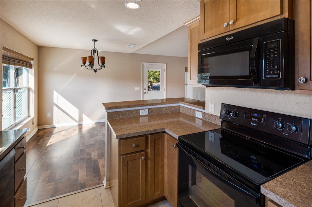 4495 Southeast 150th Street Summerfield, FL 34491 - Photo 16 of 76 a kitchen with a stove and a microwave