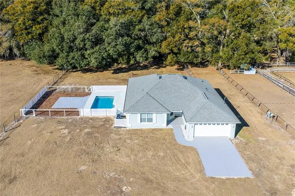 an aerial view of a house with a yard