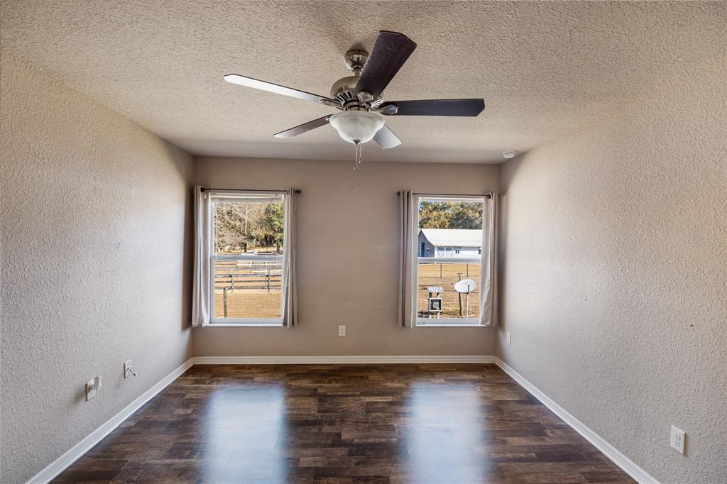 4495 Southeast 150th Street Summerfield, FL 34491 - Photo 22 of 76 wooden floor in an empty room with a window