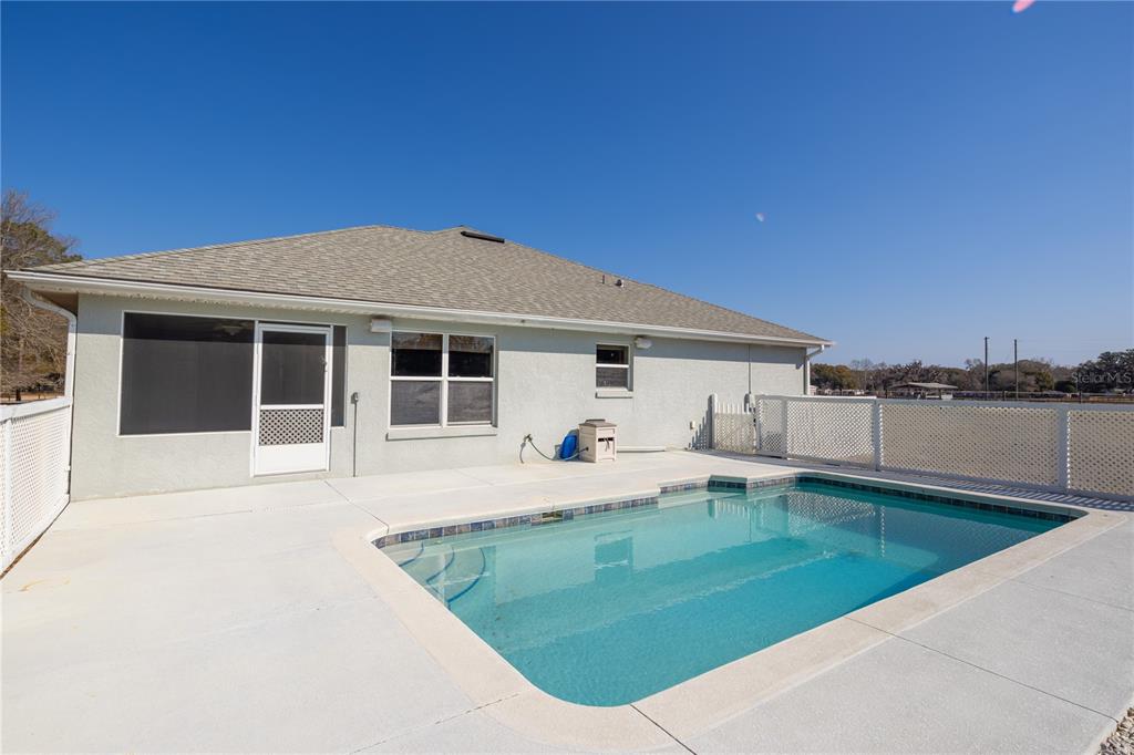 4495 Southeast 150th Street Summerfield, FL 34491 - Photo 30 of 76 a front view of a house with a yard table and chairs