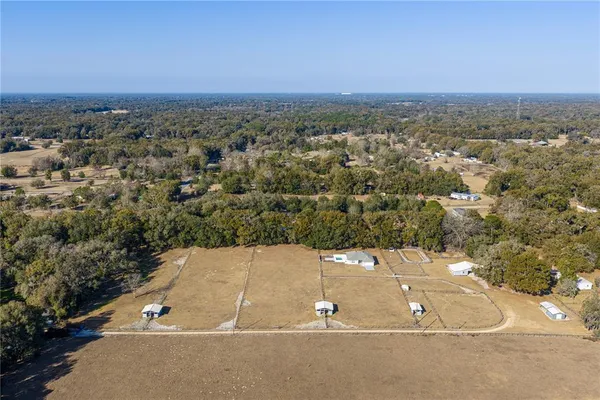 an aerial view of a house with yard