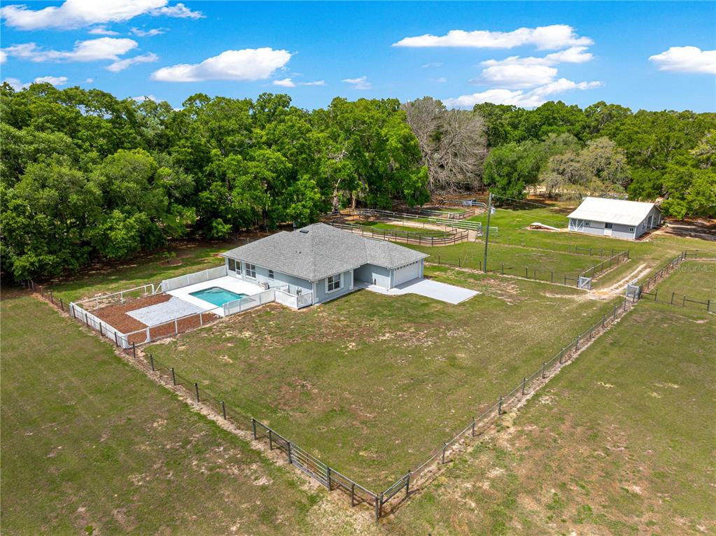 4495 Southeast 150th Street Summerfield, FL 34491 - Photo 32 of 76 a view of a swimming pool with an outdoor space and seating area